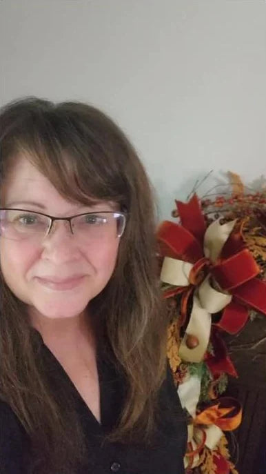 Rachel beside a fall garland she styled